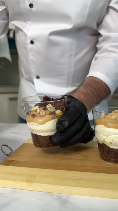 The chef decorates the cake in the kitchen. Close-up of the chef preparing 스톡 동영상 245537359