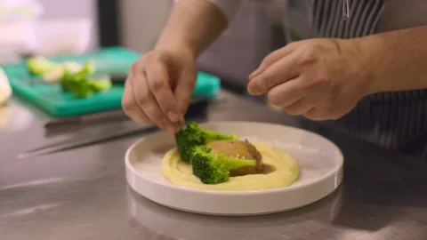 The chef decorates a dish with broccoli. Stock Footage 277131941