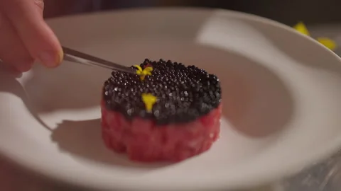 Chef Decorates Dish Of Fish And Black Caviar With Small Flowers. Stock Footage 275514993