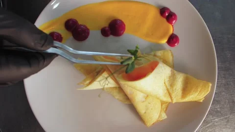The chef decorates the dish with food, breakfast, stuffed pancakes Video stock 149407938