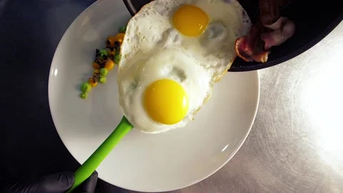 The chef decorates the dish with food, breakfast, fried egg, with tomatoes Stock Footage 149409003