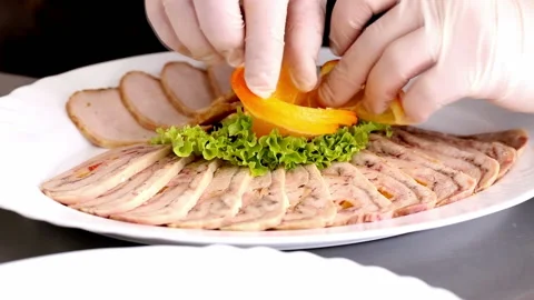 Chef decorates dish with slices of orange before serving Stock Footage 98763832