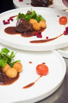 The chef decorates the dishes before serving Stock Photos
