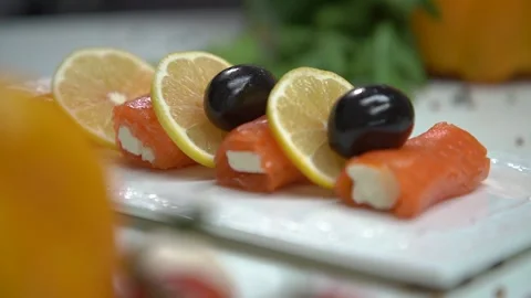 Chef decorates the fish rolls with olives Video stock 160494852