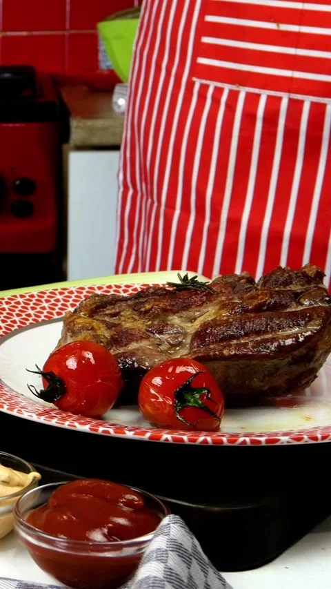 Chef decorates fried meat in plate with fried cherry tomatoes and rosemary. Stock Footage 160289896