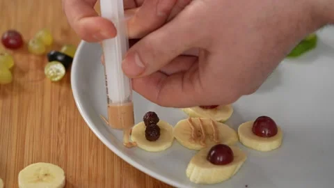 Chef decorates fruit with cream Stock Footage 183523662