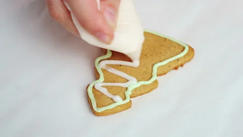 Chef decorates gingerbread making pattern of Christmas tree Stock Footage 217397211
