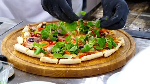 The chef decorates the greenery ready pizza Stock Footage 232578028