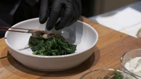 Chef Decorates His Special Fish Dish with mushrooms. Stock Footage 120255225