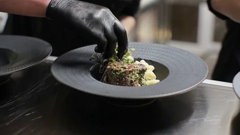 The chef decorates a meat dish Stock Footage 85461849