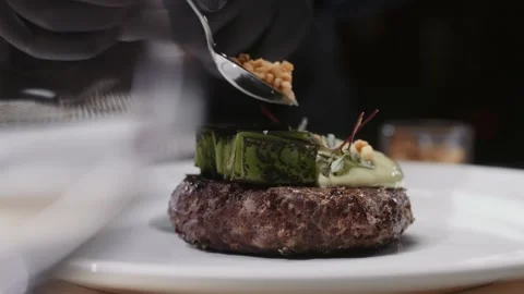 Chef decorates meat on a plate Video stock 168193958