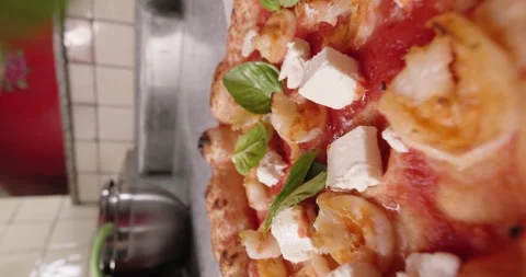 Chef decorates pizza with basil before serving, shrimp pizza. Italian cuisine Stock Footage 260938831