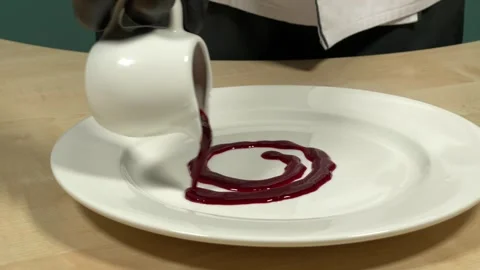 The chef decorates the plate with sauce Stock Footage 306803871
