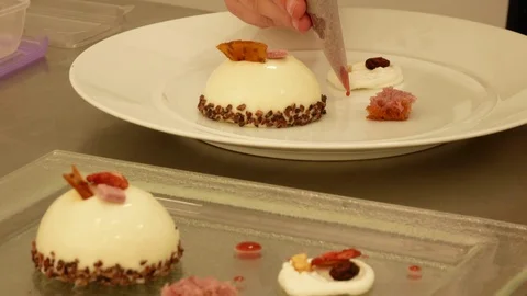 The chef decorates a plate with a sweet dessert Stock Footage 96164853