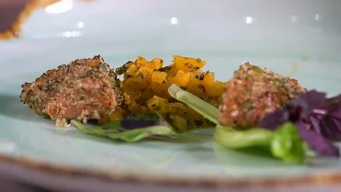 Chef decorates a platter with Greens Stock Footage 97881171