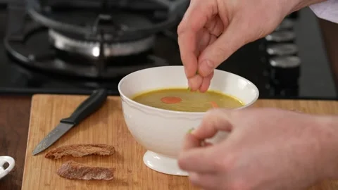 Chef decorates the soup Stock Footage 183500313