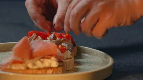 Chef decorates a spicy red pepper Making a Sandwich Mediterranean cuisine Video stock 129578857
