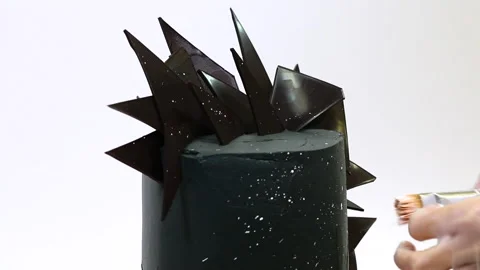 Chef decorates stylish brutal black cake with pieces of chocolate Stock Footage 151609498