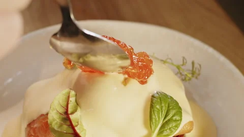 Chef decorates with a tablespoon red caviar benedict toast with watercress salad Video stock 151294950