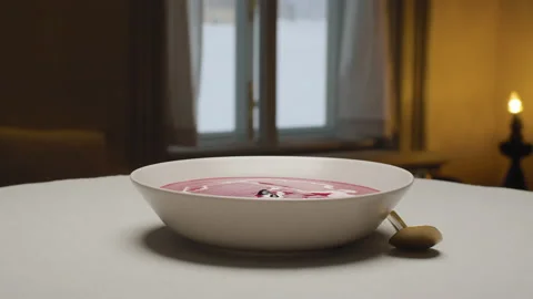 Chef decorating beetroot cream soup Stock Footage 147437804