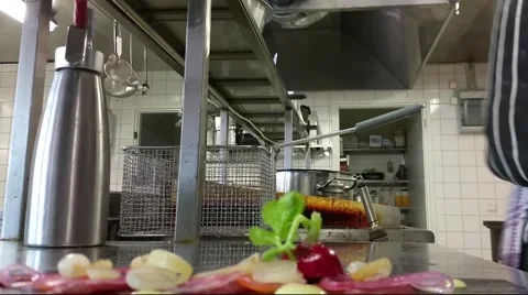 A Chef decorating deer carpaccio dish, at a restaurant kitchen Stock Footage 55049530