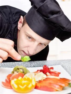 Chef decorating delicious fruit plate Stock Photos