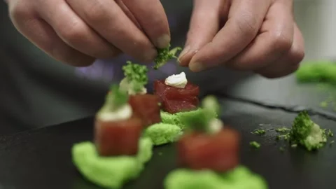 Chef decorating gourmet canapes with microgreens, close-up Stock Footage 172018962