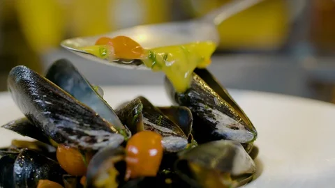 Chef is decorating the mussel dish Stock Footage 126038932