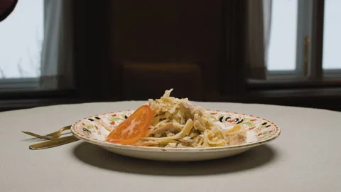 Chef decorating pasta with sliced tomato Stock Footage 147443979