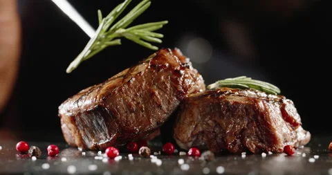 Chef decorating a plate with freshly grilled meat . Cooker adding a piece of Stock Footage 143355802