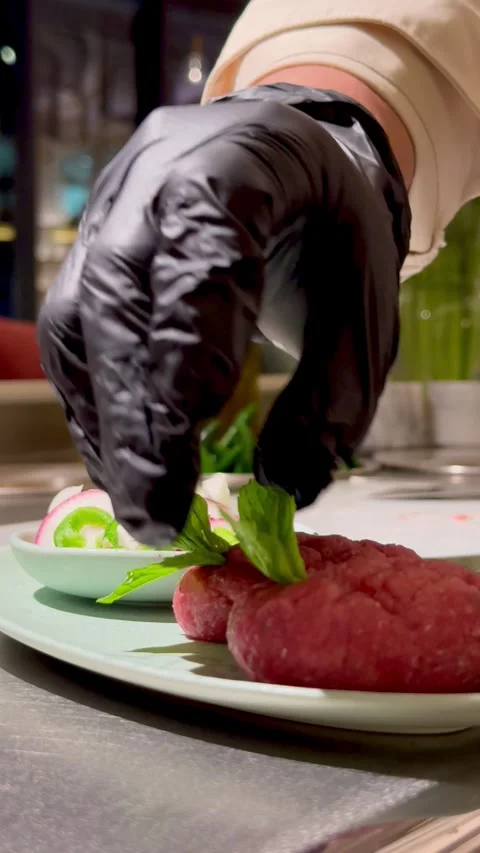 Chef decorating raw Kibbeh with fresh mint leaves Video stock 334627216