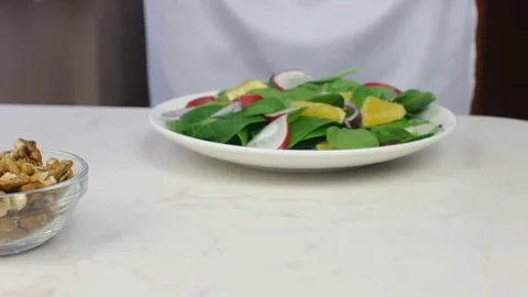 Chef Decorating Spinach Salad with Walnuts Stock Footage 83387196