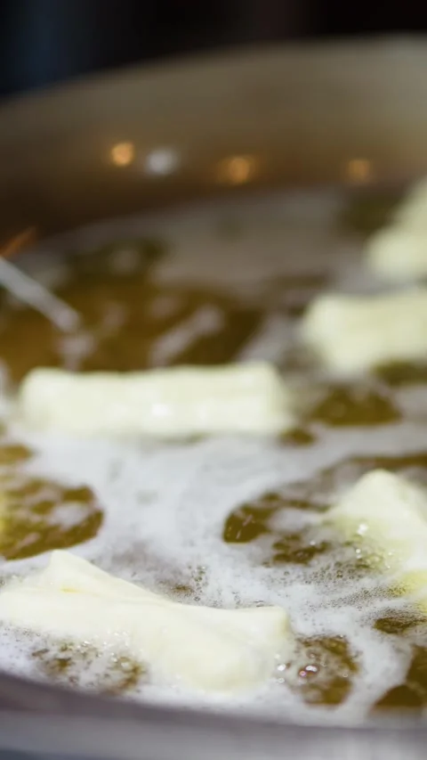 Chef Deep Frying Chinese Doughnut Sticks in Hot Oil Wok Stock Footage 341323009