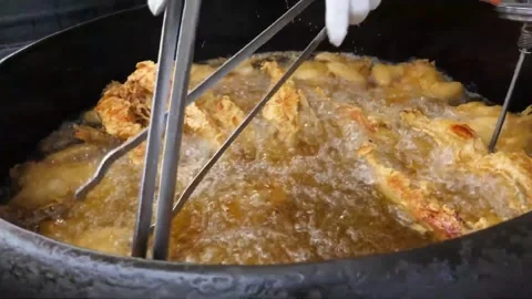 Chef Deep Frying Crispy Battered Chicken in Large Wok Video stock 343587907