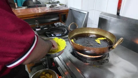 Chef Deep Frying Indian Pakoras in Hot Oil Wok Stock Footage 339125692
