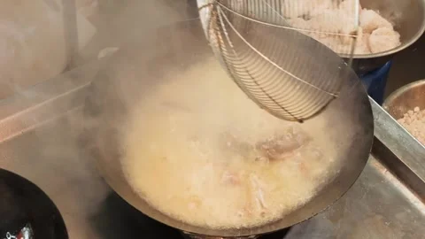 Chef Deep Frying Ingredients in a Wok with Spider Strainer Stock-Footage 344223042