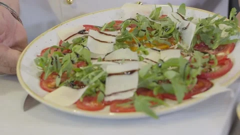 Chef demonstrates a ready-made dish of tomatoes Stock Footage 218166180