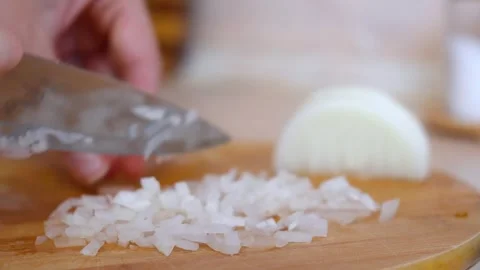 Chef dicing fresh white onion on wooden cutting board Stock Footage 327663404