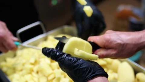 Chef dicing potatoes in a restaurant kitchen in slow motion Stock-Footage 297801215