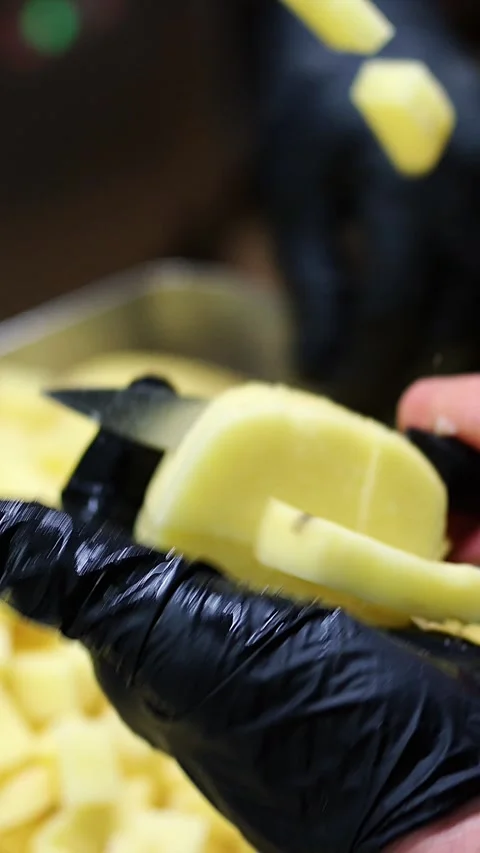 Chef dicing potatoes in restaurant kitchen slow motion Stock Footage 297801247