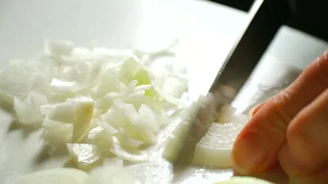 Chef dicing white onion on cutting board Stock Footage 311941292