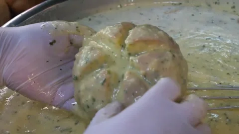 Chef Dipping Korean Cream Cheese Garlic Bread in Herb Butter Sauce Video stock 343587474