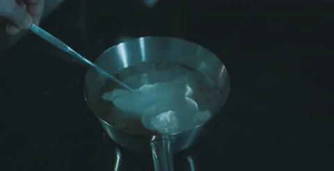 Chef dips ingredient into pot with chopsticks Stock Footage 204973935