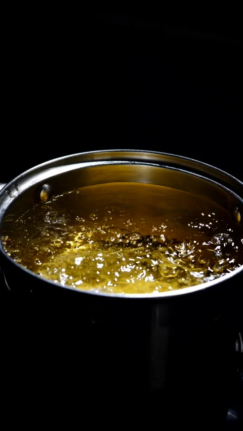 Chef dips potato pancakes into boiling oil. Stock Footage 308821940