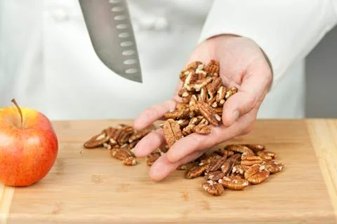 Chef display pecans in hand Stock Photos