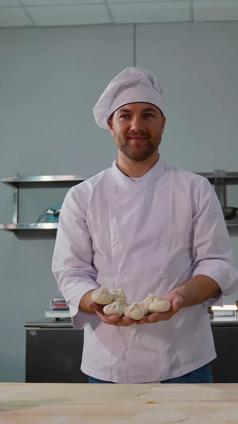 Chef Displaying Handmade Dumplings in Kitchen Stock Footage 299664905
