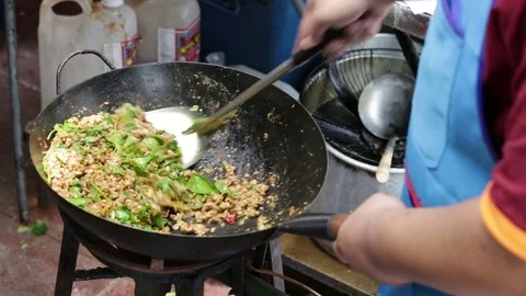 Chef doing pork fried with basil and seasoned. Stock Footage 81675252