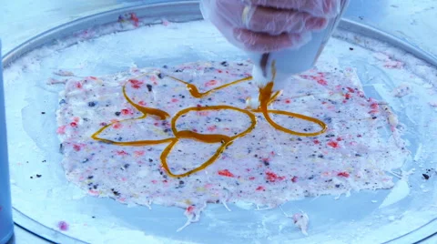 Chef draws a flower out of a jam in the ice and roll, twisting rolls Stock Footage 66879109