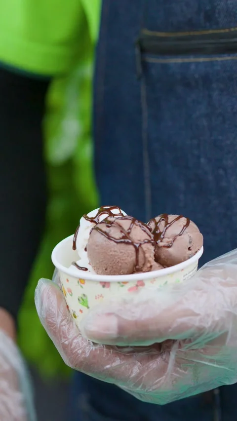 Chef Drizzling Chocolate Syrup and Condensed Milk on Ice Cream Stock Footage 341842599