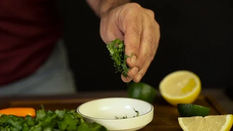 Chef Drop cilantro at Food Stock Footage 104983373